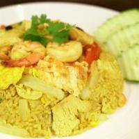 Pineapple Fried Rice · Yellow turmeric stir-fried rice with shrimp, chicken, pineapple, raisins, cashew nuts, egg, ...