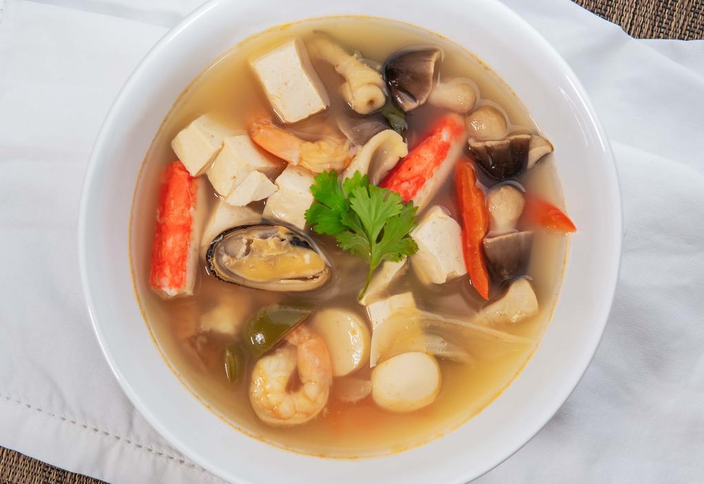 Combination Spicy Seafood Soup · Shrimp, calamari, green mussel with mushroom, basil lemongrass, green and brown onions, lime juice, carrots, red and green bell peppers.
