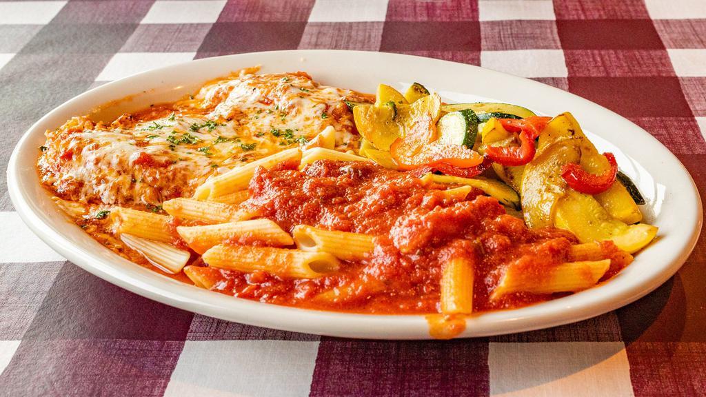 Chicken Parmigiana · Chicken breast sautéed in white wine and olive oil topped with melted mozzarella, served with pasta and vegetables.