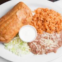 Chimichanga Plate · Deep fried burrito filled with choice of meat, lettuce, tomato, onion and cheese. Rice, bean...