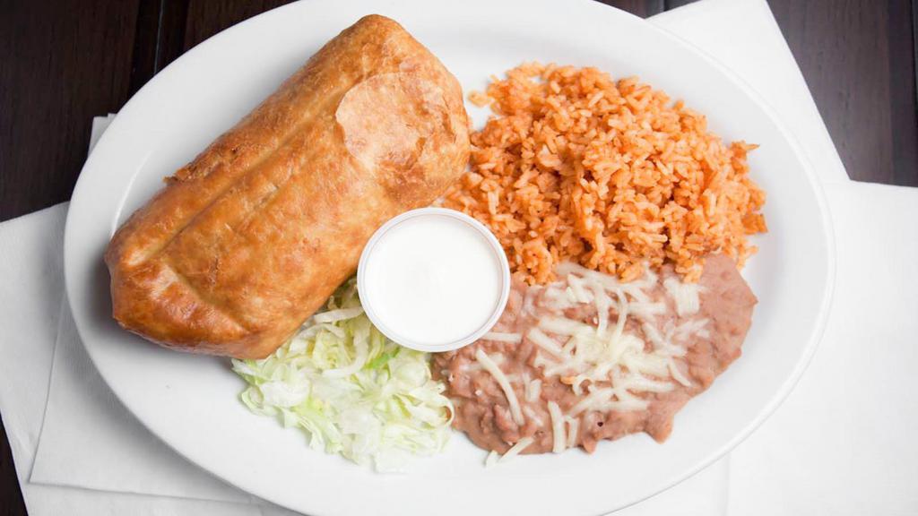 Chimichanga Plate · Deep fried burrito filled with choice of meat, lettuce, tomato, onion and cheese. Rice, beans, and sour cream served on the side.
