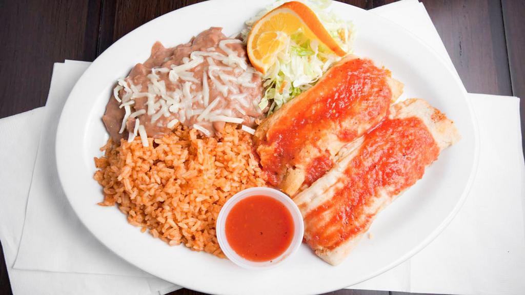 Two Tamales Plate · Two tamales filled with pork and served with rice and beans.