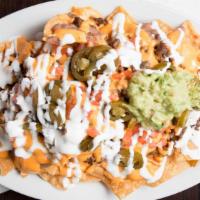 Super Nachos · Deep fried tortilla chips, topped with choice of meat, refried beans, choice of nacho or jac...