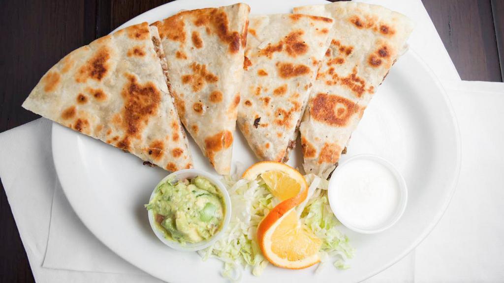 Meat Quesadilla · Grilled flour tortilla, filled with a choice of meat and a cheesy filling. Served with sour cream and guacamole.