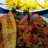Arroz Con Pollo · Chicken is baked in a casserole with yellow rice, olive oil, tomatoes, onions, green peppers...