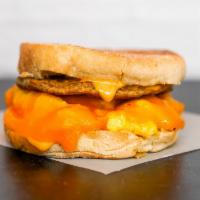English Muffin, Sausage, Egg, & Cheddar Sandwich · 2 scrambled eggs, melted Cheddar cheese, breakfast sausage, and Sriracha aioli on a toasted ...