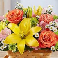 Fields Of Europe™ Basket · A delightful bouquet that reminds one of freshly picked flowers. It includes orange roses an...