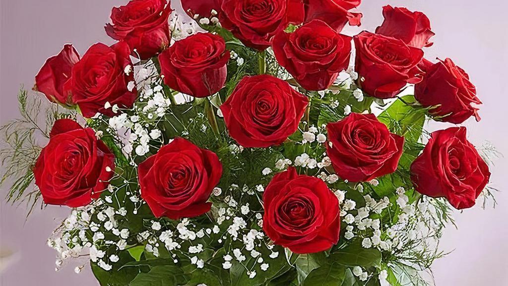 Rose Elegance™ Premium 12 Long Stem Red Roses · Surprise the one you love with this beautiful arrangement.Beautifully arranged by our expert florists with lush greenery inside a classic glass vase.