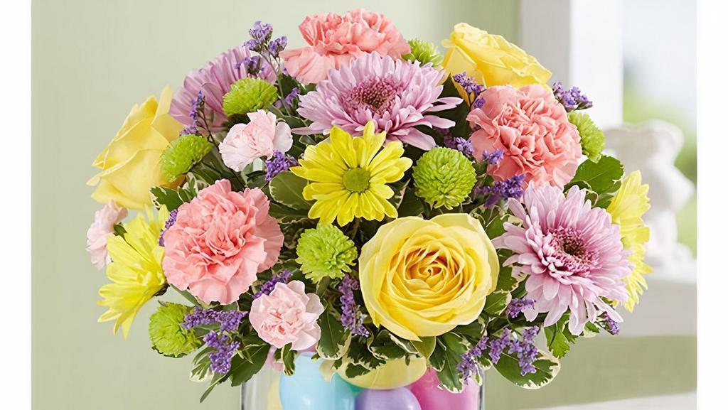 Easter Egg-Stravaganza · This bright and pastel bouquet is the perfect gift for family and friends. It includes all-around arrangement with yellow roses, daisy poms, lavender cremones, pink carnations and mini carnations, purple limonium and green button poms; accented with assorted greenery. Grab it for your next party or even a welcome home gift.