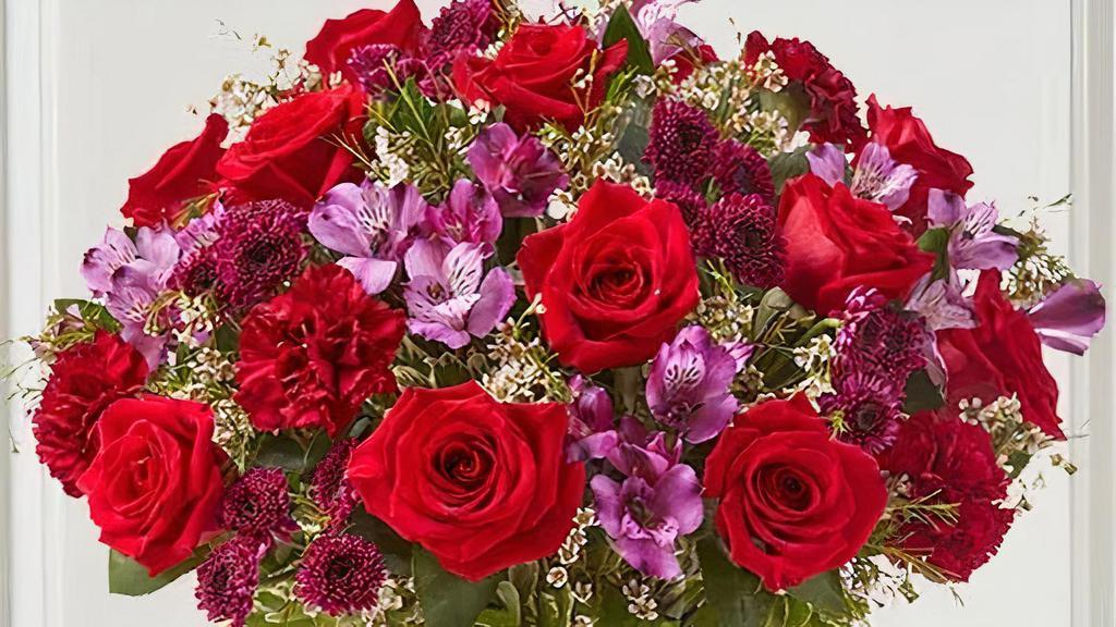 Majestic Moment™ Bouquet · Show your love with our romantic bouquet. Gathered with rich red, purple and burgundy blooms, and accented by lush greenery. Designed in our striking hammered bell pitcher.