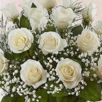 Rose Elegance™ Premium 12 Long Stem White Roses · You can never go wrong with white roses!. Arranged in a clear vase our roses are gathered wi...