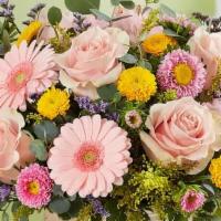 Spring Sentiment™ Bouquet · This bouquet represents everything Spring. Soft pink and yellow blooms are loosely gathered ...