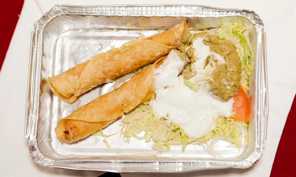 Flautas · Two crispy corn tortillas, stuffed with shredded chicken or beef. Topped with sour cream, guacamole, and cotija cheese.
