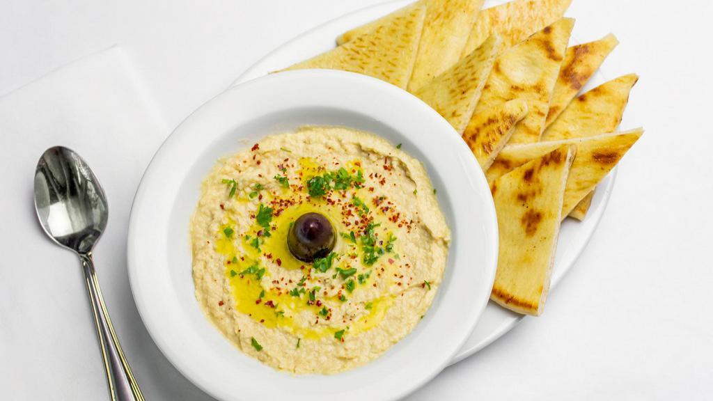 Hummus · garbanzo beans with seasoning. Served with warm pita bread and chips.