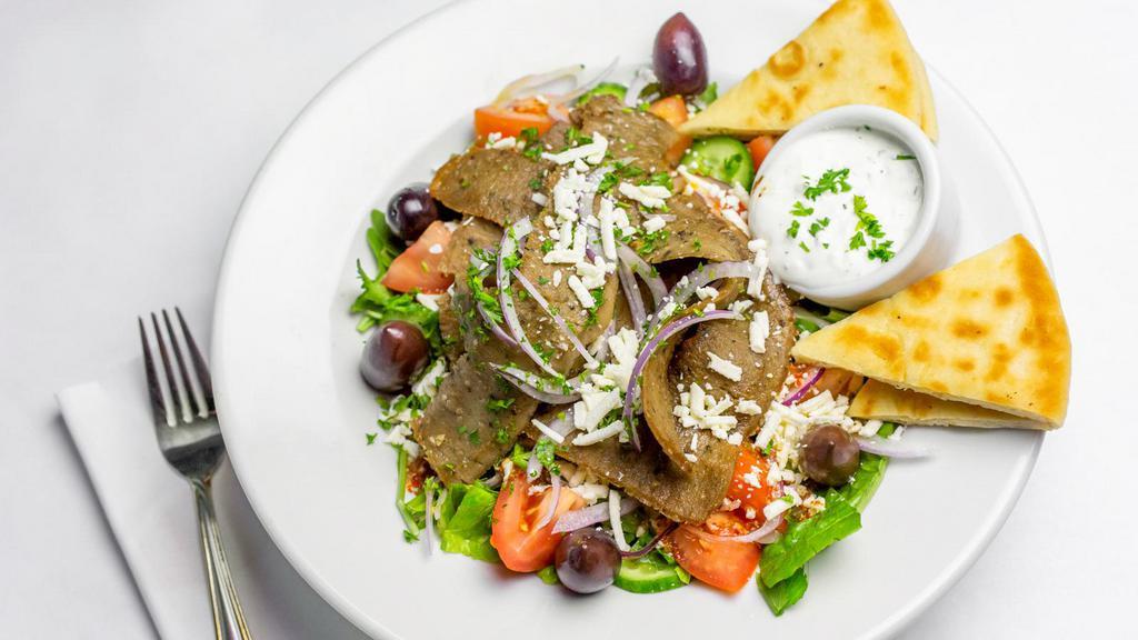 Gyro Salad · greek salad with gyro meat on the top and Served with pita bread, tzadziki sauce and dressing