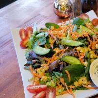 Garden Salad · Fresh organic mixed greens, cucumbers, corn, carrots, tomatoes, and our special house dressi...