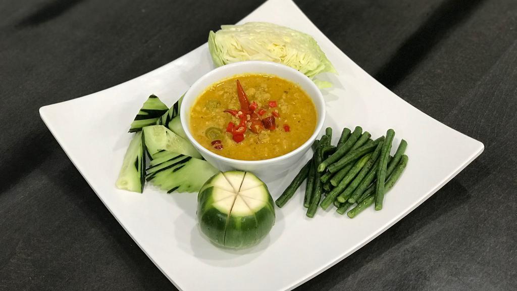 Prahok K'Tiss · A traditional Cambodian dip made with ground chicken, prahok, kroeung ( a paste made with a blend of lemongrass, turmeric, kaffir lime leaves, galangal, garlic, shallot & dry chili pepper), coconut milk, peanut, served with a variety of fresh vegetables to dip in.
