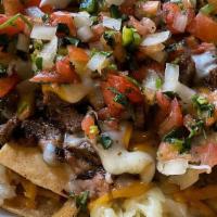 Vallejo'S Nachos · Crispy tortilla chips smothered with refried beans, melted Jack and Cheddar cheese and choic...