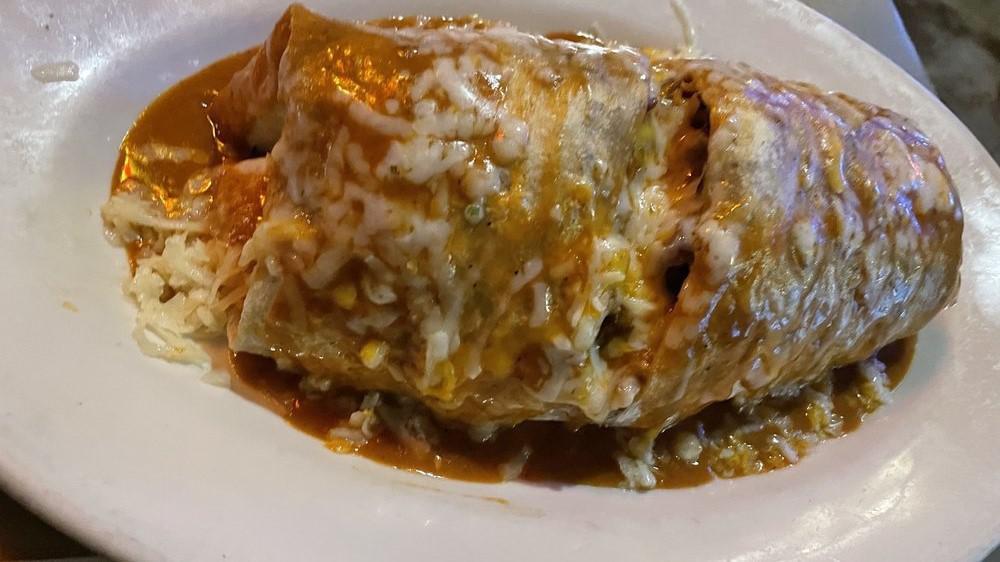 Zapata Burrito · A jumbo flour tortilla loaded with your choice of charbroiled chicken, carne asada (steak) or carnitas (pork) & rice, frijoles de la olla (whole beans), pico de gallo, guacamole & lettuce topped with our enchilada sauce & melted cheese.