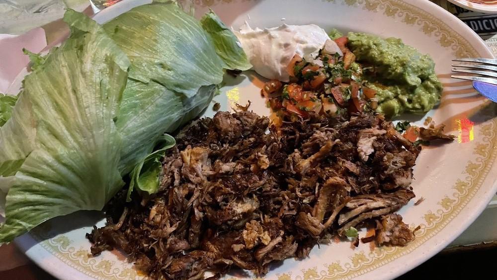 Carnitas Plate · Tender chunks of simmered carnitas (pork] served with refried beans & rice, pico de gallo, guacamole, sour cream, roasted jalapeño peppers & corn or flour tortillas.