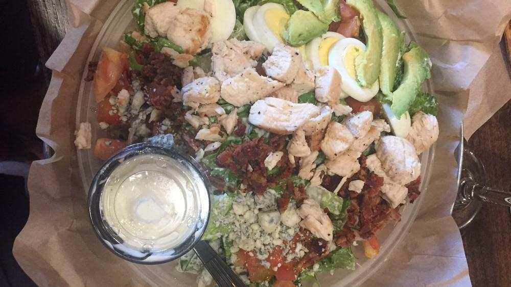California Cobb · Romaine lettuce, bacon, green onions. Blue cheese, sliced eggs, grilled chicken breast, avocado, tomatoes. Served with blue cheese or ranch dressing.