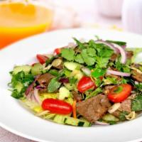 Spicy Beef Salad · Sliced grilled beef, mixed greens. lemongrass, carrots, cucumbers, tomatoes, onions and mint...