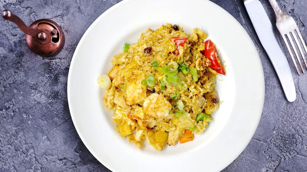 Pineapple Fried Rice · Chicken, shrimp, eggs, curry powder, bell peppers, pineapple, onions, cashews and raisins.