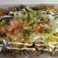 Frito Plate · Frito chips topped with refried beans, cheddar cheese, your choice of meat, sour crème, pico...
