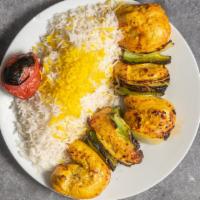 Chicken Shish Kabob · Marinated chunks of chicken breast with bell peppers and onions served with grilled tomato a...
