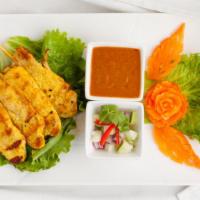 Chicken Satay · Chicken marinated in coconut milk with herbs and spices and grilled. Served with peanut sauc...