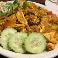 Yellow Curry Fried Rice · Stir fried rice with your choice of meat, yellow curry powder, raisin, egg, onion, pea, carr...