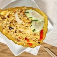Pineapple Fried Rice · Stir-fried rice with shrimp, chicken, pineapple, onions, egg, cashew nuts, and curry powder.
