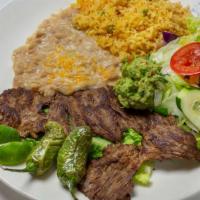 Carne Asada · Tender sliced beef topped with sautéed onions. Served with lettuce, guacamole & pico do gallo.