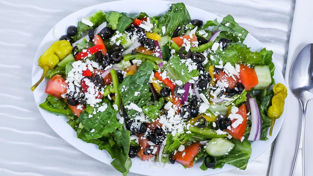 Greek Salad · Romaine lettuce, feta cheese, Greek black olives, red onions romaine lettuce, feta tomatoes, cucumber, and bell peppers.