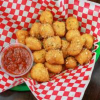 Garlic Knots · Deep fried dough covered in melted garlic butter and covered with parmesan cheese.