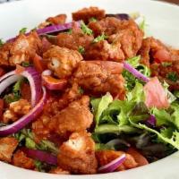 Boneless Buffalo Chicken Salad · Crispy chicken tossed in spicy buffalo sauce, applewood bacon, blue cheese crumbles, red oni...
