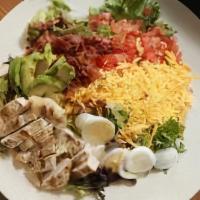 Cobb Salad · Chopped salad greens, tomatoes, crisp bacon, grilled chicken breast, hard-boiled eggs, avoca...