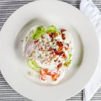 Wedge · Quarter of iceberg lettuce, blue cheese crumbles, tomatoes, red onion and bacon served with ...