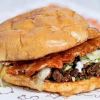 Mini Torta · The Mexican sandwich. Freshly baked Telera roll grilled to crunchy perfection, topped with y...