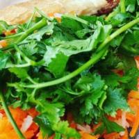 Bomb Banh Mi · Contains gluten. Vietnamese baguette with your choice of meat, pickled carrots, Daikon, fres...