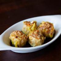 Thai Dim Sum · Open faced steam pork and shrimp dumpling. Served with a sweet and savory dipping sauce!
