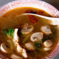 Spicy Tom Yum Soup · Hot and sour soup with chili jam, dried chiles, kaffir lime, galangal, lemongrass, mushrooms...
