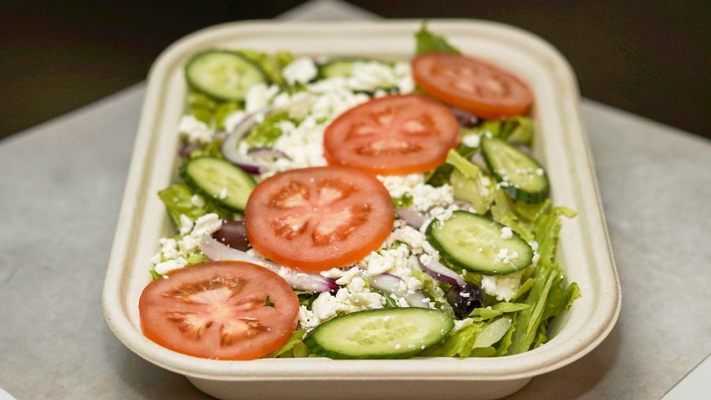 Greek Salad · Lettuce, tomatoes, onion, kalamata olives, cucumber, feta cheese, and a side of Greek dressing.