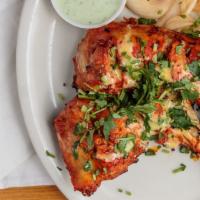 Tandoori Chicken Tikka · The royal recipe. Marinated leg and thigh of chicken grilled over charcoal to a perfect fini...