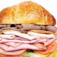 #38 Lee'S Club · Served on croissant. 
Ham, turkey, roast beef, and cheese. Served on croissant. Includes let...
