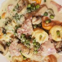 Torellini Bosciola · tortellini sauteed with ham, peas and mushrooms in a garlic cream sauce