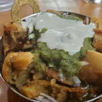 Samosa Chat · Mashed samosa is served with chickpeas, tamarind and green chutney along with onion, tomato,...