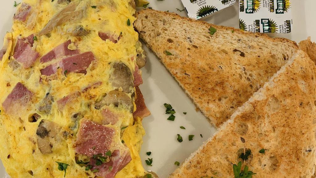 Omelettes · 4 eggs served with bread, butter, and a choice of 3 ingredients: shredded cheese, turkey bacon, onions, tomatoes, olives, bell peppers, mushrooms, and/or spinach. Add Avocado, Andouille Sausage for an additional charge.