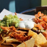 Benny’S Nachos · Generous portion of tortilla chips topped with Jack cheese, pico de gallo, sour cream, guaca...