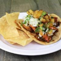 Al Pastor Taco · Achiote marinated pork, grilled pineapple, onion-cilantro, salsa, served on a large 5” yello...